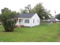 House with a large grassy backyard and a fenced perimeter at 2312 E 22Nd St, Muncie, IN 47302