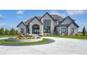 Elegant home exterior with stone facade and landscaping at 9760 Windy Hills Dr, Zionsville, IN 46077