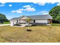 Ranch style home with gray siding, stone accents, and a two-car garage at 10614 N 300 E, Morristown, IN 46161