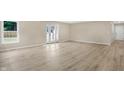 Bright and airy living room featuring light wood-look flooring at 10614 N 300 E, Morristown, IN 46161