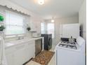 White kitchen with gas stove, microwave, and dishwasher at 1683 Conner St, Noblesville, IN 46060