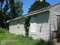 Side view of a small house needing repairs, boarded windows at 3318 S Rybolt Ave, Indianapolis, IN 46221