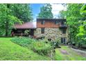 Two story home with stone and wood exterior, nestled in woods at 9307 E Dill Rd, Morgantown, IN 46160
