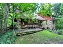 Log cabin home nestled in a lush forest setting at 9307 E Dill Rd, Morgantown, IN 46160