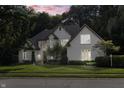 Two story white brick house with manicured lawn at dusk at 11988 Windpointe Pass, Carmel, IN 46033