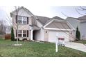 Two-story house with brick and siding, two-car garage, and for sale sign at 10429 Serviceberry Dr, Avon, IN 46123