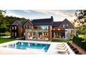 Luxury home with a large pool and outdoor seating area at 9700 Windy Hills Dr, Zionsville, IN 46077