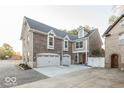 Brick house with a three-car garage and large driveway at 437 W 86Th St, Indianapolis, IN 46260