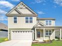 Two-story house with a two-car garage and front porch, showcasing a mix of siding colors at 1550 Hanover St, Danville, IN 46122