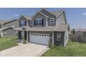 Two-story house with gray siding, brick accents, and a two-car garage at 2277 Maple Stone Ln, Greenwood, IN 46143