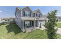 Two-story house with gray siding, brick accents, and a two-car garage at 2277 Maple Stone Ln, Greenwood, IN 46143
