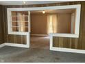 Living room features built-in shelving and wood paneling at 2506 Morton St, Anderson, IN 46016