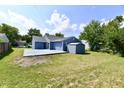 Backyard view showing a blue house with a patio, shed and grassy area at 2813 Grassy Creek Dr, Indianapolis, IN 46229