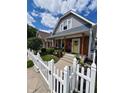 Charming 2-story home with gray siding and white picket fence at 32 E Caven St, Indianapolis, IN 46225
