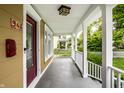 Front porch with white railings and entry door at 946 Tecumseh St, Indianapolis, IN 46201