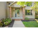 Front entrance with brick columns, glass door and landscaping at 1936 Broadmoor Ln, Columbus, IN 47203