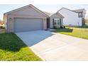 New construction home with gray garage door and driveway at 6205 Card Blvd, Indianapolis, IN 46221