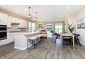 Open concept kitchen and dining area with white cabinets, island, and hardwood floors at 18462 Depoe Ln, Westfield, IN 46074