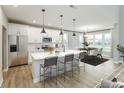 Modern kitchen features stainless steel appliances and an island with seating at 1098 Gatewick Ct, Greenwood, IN 46143