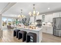 Spacious kitchen with white cabinets, large island, stainless steel appliances, and hardwood floors at 1099 Gatewick Ct, Greenwood, IN 46143