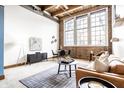 Spacious living area with exposed brick, large windows, and comfortable seating at 735 Lexington Ave # Apt 8, Indianapolis, IN 46203