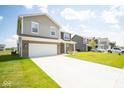 Two-story home with brick exterior and driveway at 91 Booth St, Whiteland, IN 46184