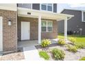 Front porch with brick columns and landscaping at 91 Booth St, Whiteland, IN 46184