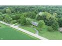 Aerial view of house on a large lot with a circular driveway and mature trees at 4463 W 700 S, Trafalgar, IN 46181