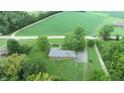An aerial view of a ranch home with a large backyard, situated on a quiet country road at 4463 W 700 S, Trafalgar, IN 46181