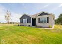 A charming house exterior with a neatly kept lawn at 3809 S Woodfield Dr, New Palestine, IN 46163
