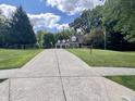 Two-story home with a three car garage and a large yard at 303 Wellington Overlook, Noblesville, IN 46060
