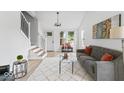 Bright living room features a gray sofa, stylish coffee table, and a view of the staircase at 1046 Dawson St, Indianapolis, IN 46203