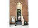 Brick entryway with a black door and metal stairs at 571 Lockerbie S Cir, Indianapolis, IN 46202