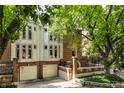 Brick townhouse with a two-car garage and landscaping at 571 Lockerbie S Cir, Indianapolis, IN 46202