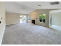 Bright living room with vaulted ceilings and neutral carpeting at 8124 Farmhurst Ln, Indianapolis, IN 46236