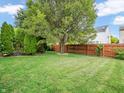 Spacious backyard with lush lawn and wooden privacy fence at 8321 Flicker Ct, Indianapolis, IN 46237