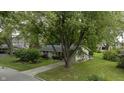 Ranch home with spacious yard, large tree, and convenient ramp access at 451 Emerson Rd, Carmel, IN 46032