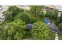 House with above ground pool, surrounded by lush trees and green lawns at 451 Emerson Rd, Carmel, IN 46032