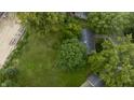 Single story home nestled among large trees and green lawns at 451 Emerson Rd, Carmel, IN 46032