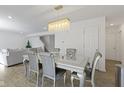Elegant dining room with glass table and chandelier at 10125 Caprock Canyon Dr, Indianapolis, IN 46229
