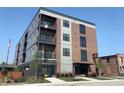 Brick apartment building with modern design, featuring balconies and large windows at 150 S Main St # 404, Franklin, IN 46131