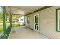 Inviting front porch with green railings and a porch swing at 3649 N Sadlier Dr, Indianapolis, IN 46226