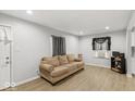Bright living room with wood-look floors and a comfortable sofa at 3649 N Sadlier Dr, Indianapolis, IN 46226
