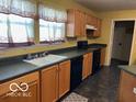 Bright kitchen with oak cabinets and black appliances at 10342 Split Rock Way, Indianapolis, IN 46234