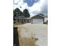 Newly built home with a two-car garage and gravel driveway at 207 N Birchwood Dr, Muncie, IN 47304