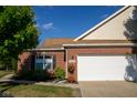 Brick ranch house with a white garage door and landscaping at 5213 Dunewood Way, Avon, IN 46123