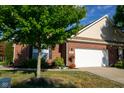 Brick ranch house with a white garage door and landscaping at 5213 Dunewood Way, Avon, IN 46123