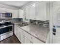Updated kitchen with stainless steel appliances and granite countertops at 4013 N Graham Ave, Indianapolis, IN 46226