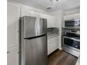 Modern kitchen with stainless steel appliances and white cabinets at 4013 N Graham Ave, Indianapolis, IN 46226