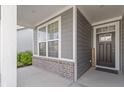 Front porch with gray door and brick accents at 17084 Cole Evans Dr, Noblesville, IN 46060